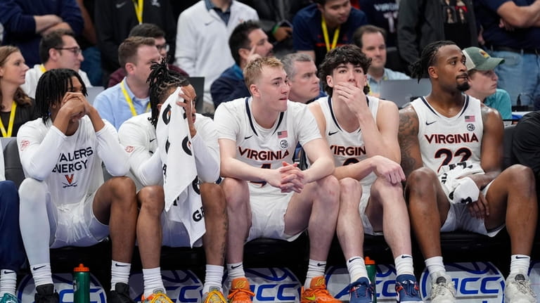 Virginia players sit on the bench to closing seconds in...