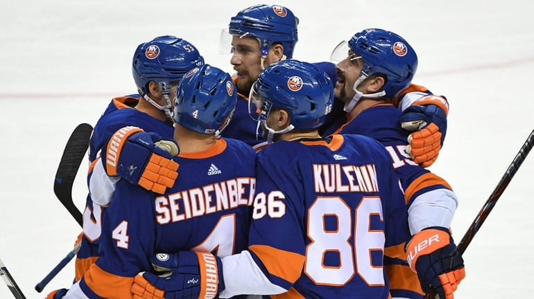 Islanders players celebrate a goal by Nikolay Kulemin against the...