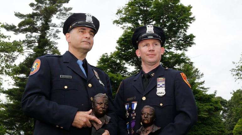 Nassau police Officer Nicholas Brando, left, and Suffolk police Officer...