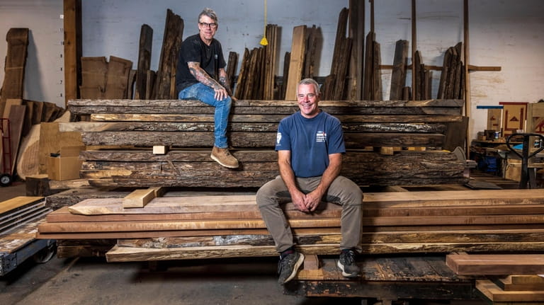 Harry Slutter, right, owner of Urban Specialty Woods in Huntington Station,...