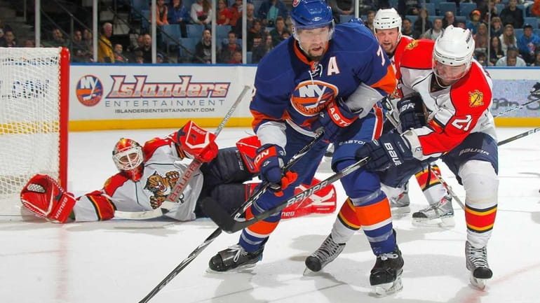 The Islanders' Trent Hunter, left, will be out indefinitely with...