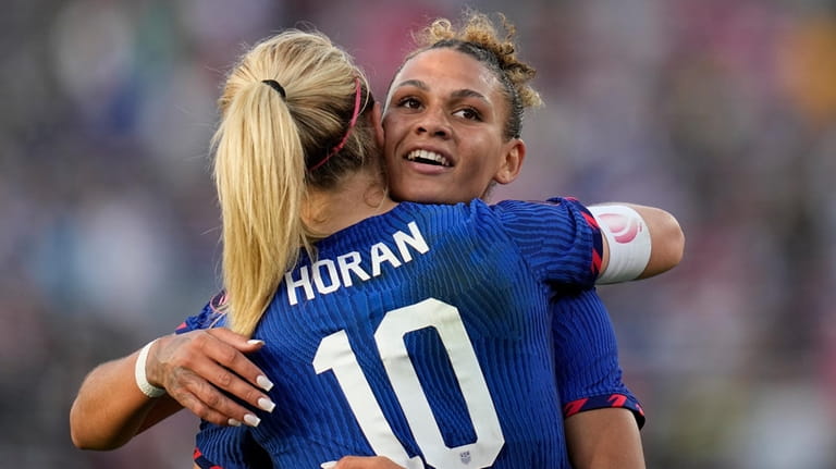 United States' Lindsey Horan (10) embraces teammate Trinity Rodman after...