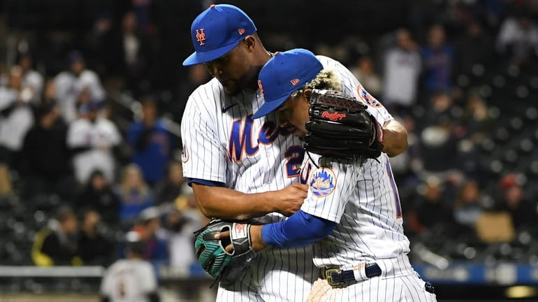 Mets relief pitcher Jeurys Familia and shortstop Francisco Lindor embrace...