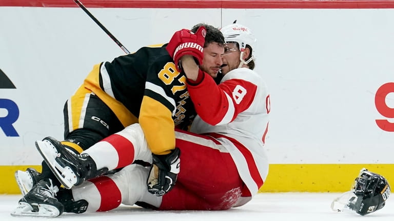 Pittsburgh Penguins' Sidney Crosby (87) lands on top of Detroit...