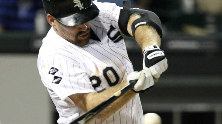 The Chicago White Sox's Kevin Youkilis hits a sacrifice fly...