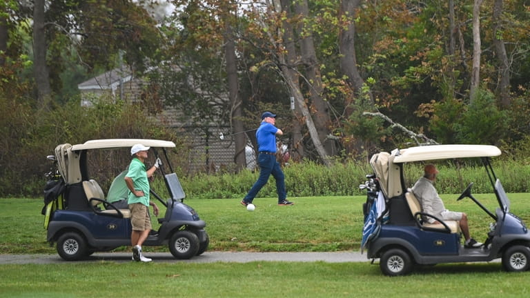 Clowds and light rain didn't stop these golfers from teeing...