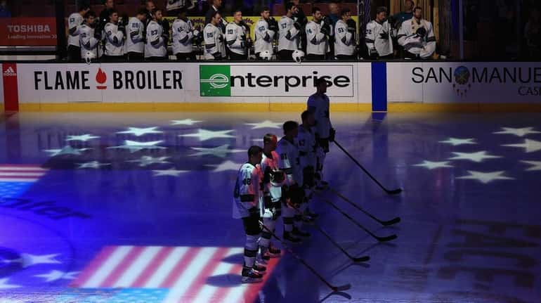 The San Jose Sharks stand for the national anthem prior...