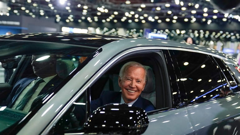 President Joe Biden drives a Cadillac Lyriq through the show...