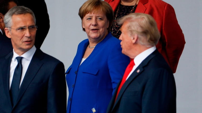 German Chancellor Angela Merkel and President Donald Trump talk during...
