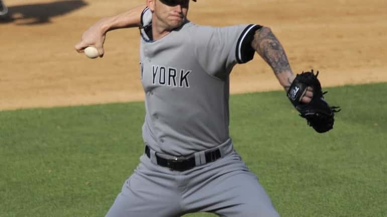 Yankees starting pitcher A.J. Burnett throws to the plate during...