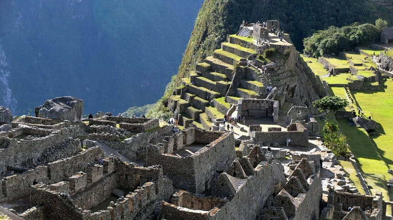 Tourists walk among the ruins of the Machu Picchu citadel....