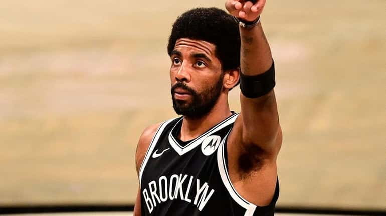 Kyrie Irving of the Nets acknowledges the fans prior to Game...