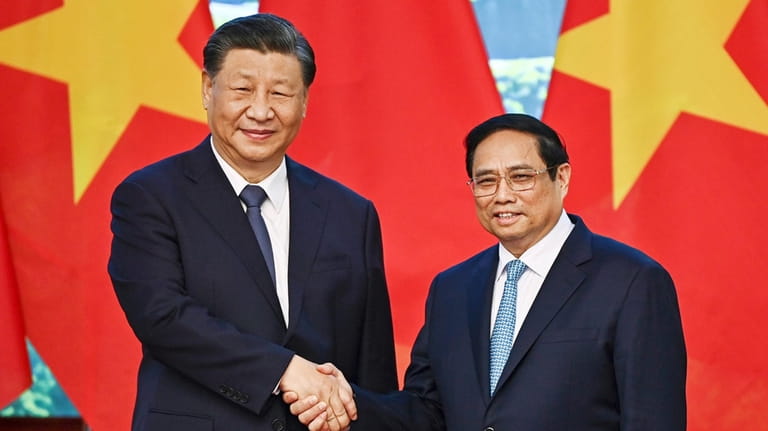 Vietnam's Prime Minister Pham Minh Chinh, right, and the China's...