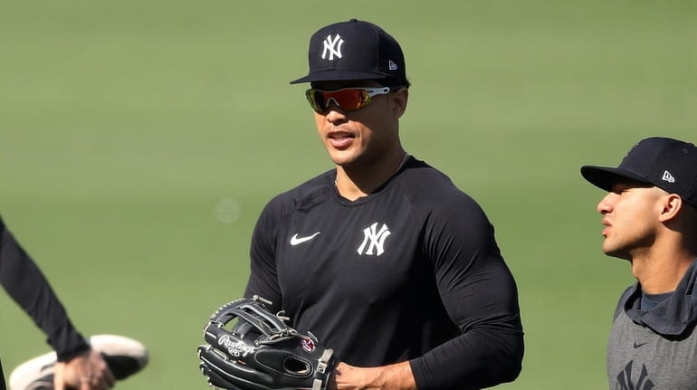Giancarlo Stanton #27 of the Yankees warms up against the...