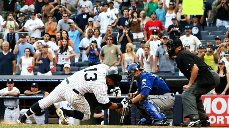 Alex Rodriguez falls after getting hit by a pitch against...