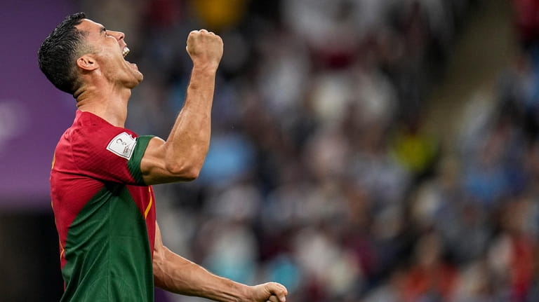 Portugal's Cristiano Ronaldo celebrates after scoring his side's opening goal...