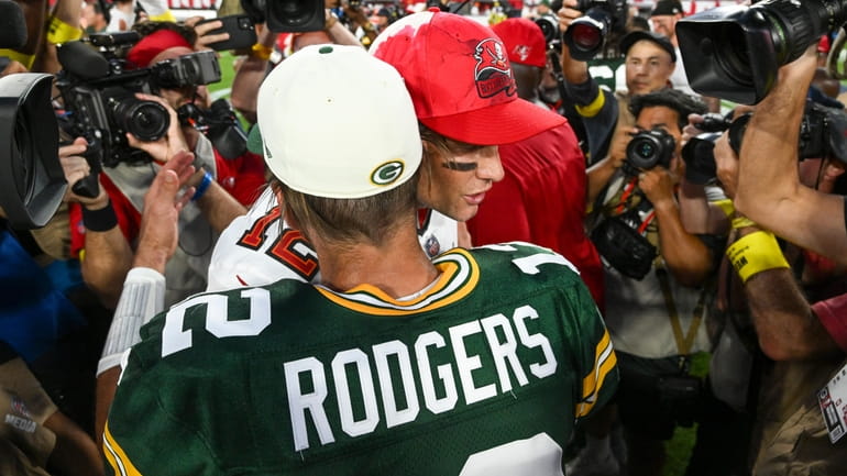 Green Bay Packers' Aaron Rodgers hugs Tampa Bay Buccaneers' Tom...