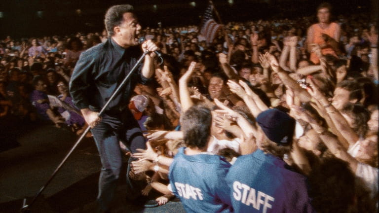 Billy Joel  sings to the crowd  in "Billy Joel:Live at...