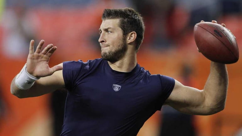Quarterback Tim Tebow warms up while still with the Denver...