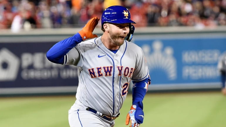 Pete Alonso #20 of the Mets rounds the bases after hitting...