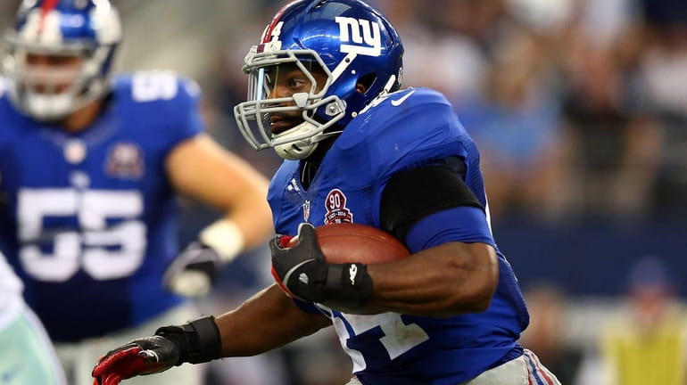 Giants rookie running back Andre Williams carries the ball against...