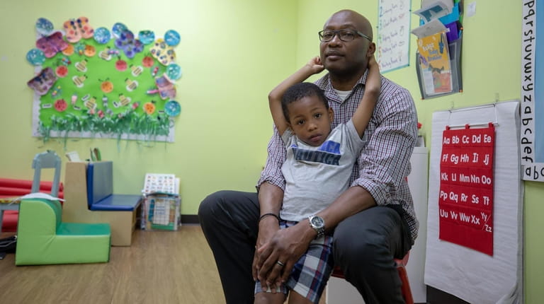 Alestair Patterson, 42, with his son Adin Patterson, 4, at...