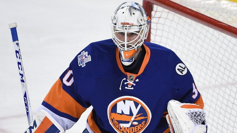 New York Islanders goalie Jean-Francois Berube protects the net against...