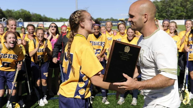 Northport's Erin Magnuson receives the championship plaque from Jeremy Thode,...
