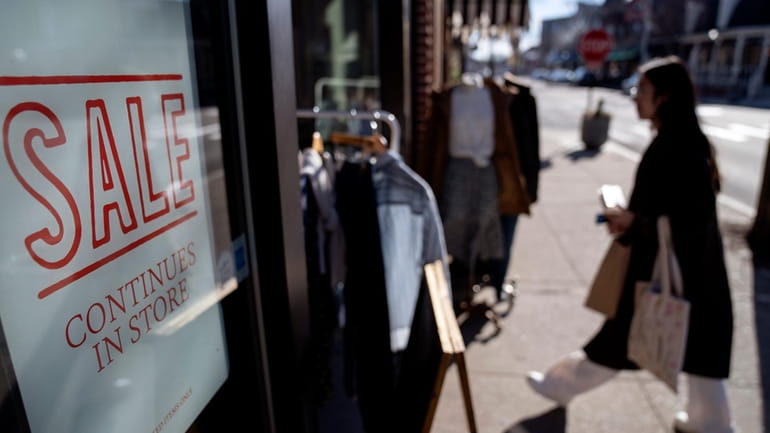 A shop holds a sidewalk sale on Feb. 10, 2023,...