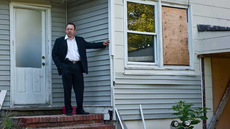 Brentwood realty broker Hector Villatoro stands outside a home on...