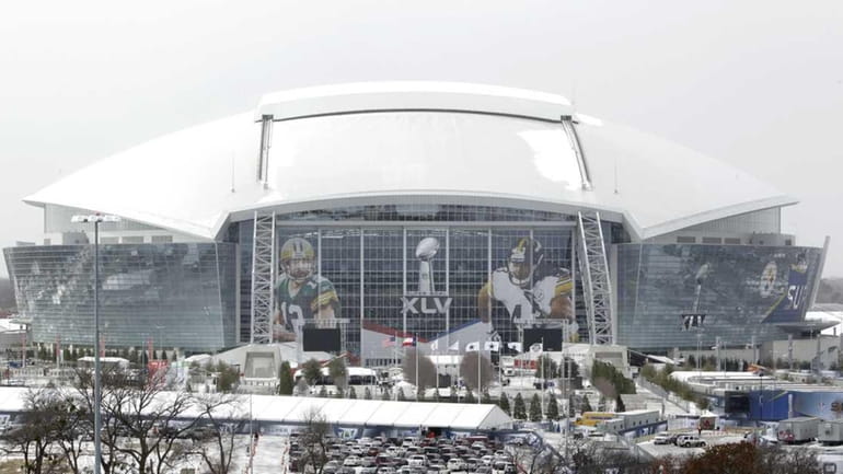 Sleet sits on top of Cowboys Stadium in Arlington, Texas,...