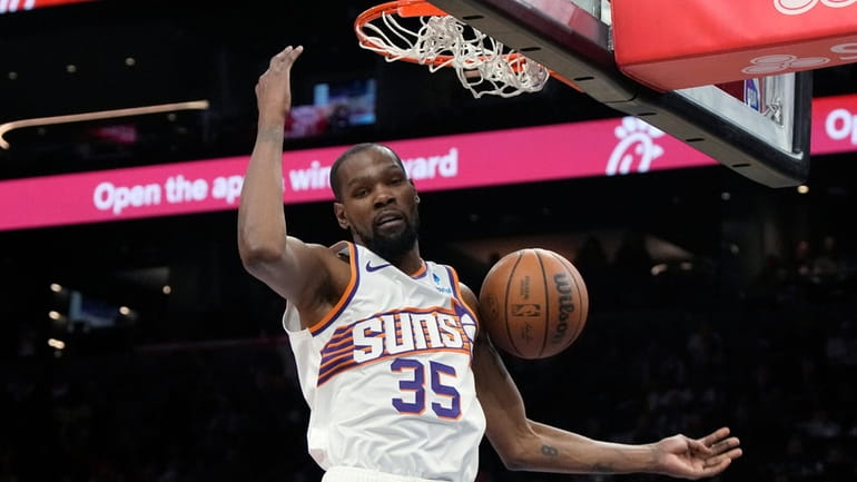 Phoenix Suns forward Kevin Durant dunks against the Philadelphia 76ers...