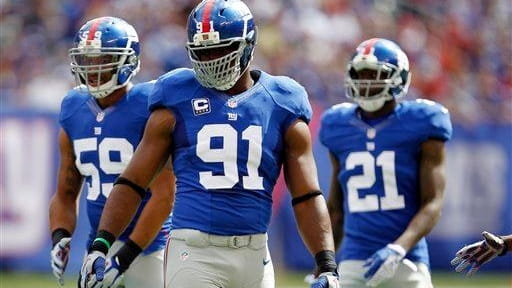 (L-R) Michael Boley, Justin Tuck and Kenny Phillips look on...