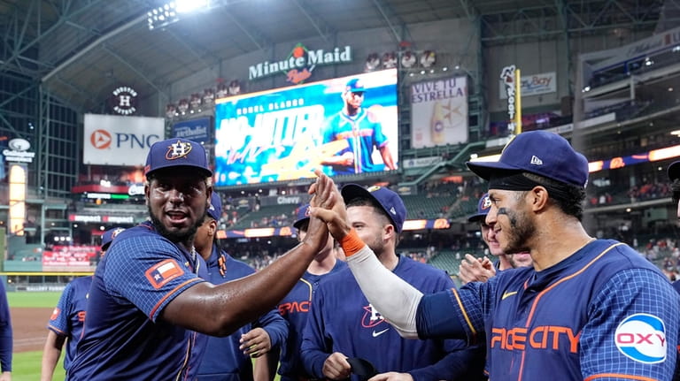 Houston Astros starting pitcher Ronel Blanco high-fives Jeremy Pena after...