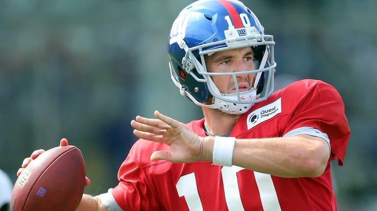 New York Giants quarterback Eli Manning #10 drops back to...