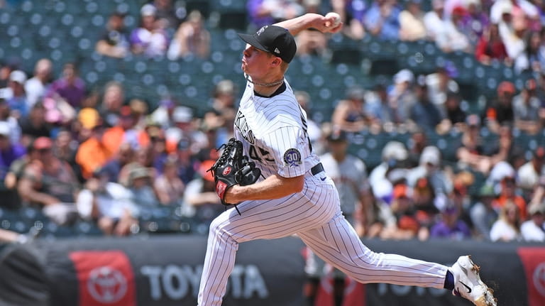 Colorado Rockies starting pitcher Chase Anderson pitches in the first...
