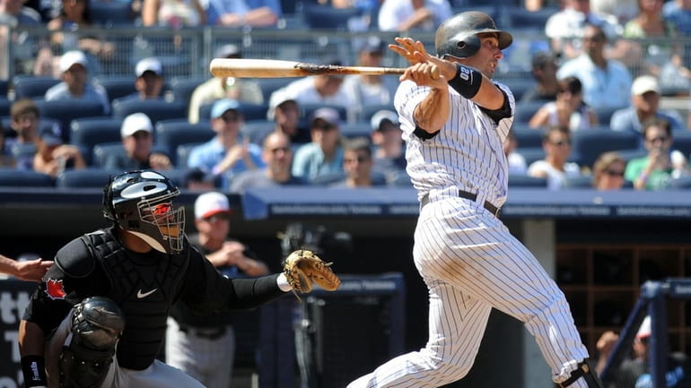 Yankees catcher Jorge Posada singles in the bottom of the...
