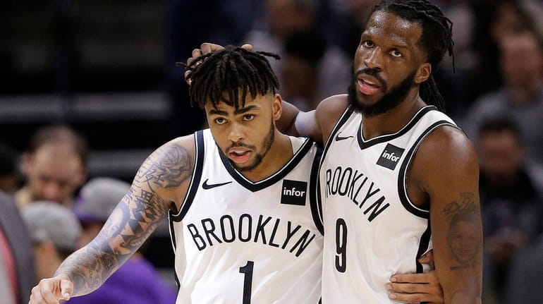 Nets' D'Angelo Russell, left, and DeMarre Carroll walk off the...