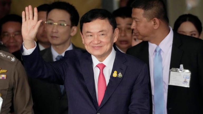 Thailand's former Prime Minister Thaksin Shinawatra, center, arrives at Don...