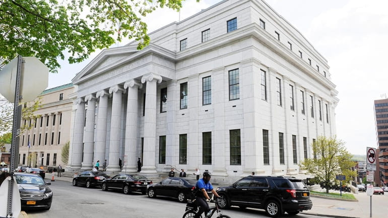 A cyclist rides past the state Court of Appeals in Albany...