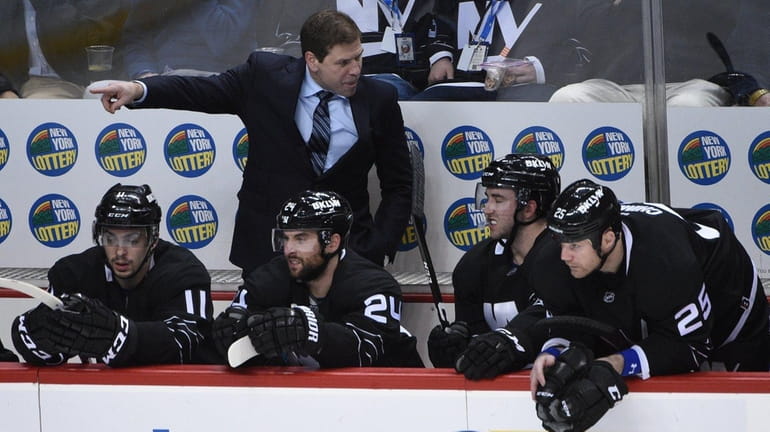 New York Islanders interim head coach Doug Weight directs his...