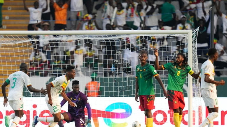 Senegal's players celebrate after their teammate Ismaila Sarr scored his...