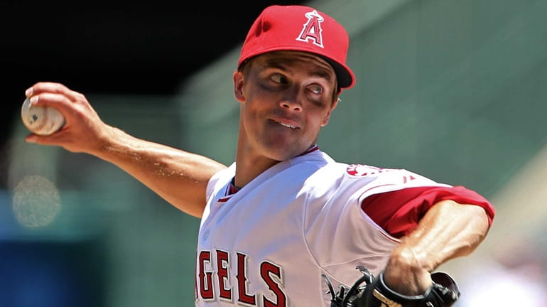 Los Angeles Angels starter Zack Greinke delivers a pitch during...