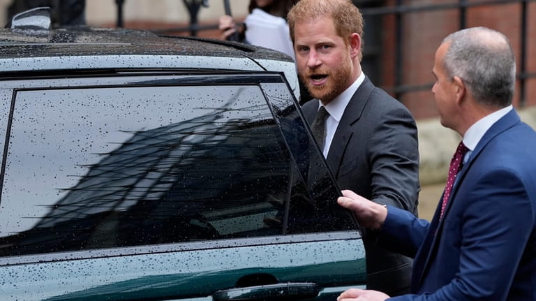 Britain's Prince Harry leaves the Royal Courts Of Justice in...