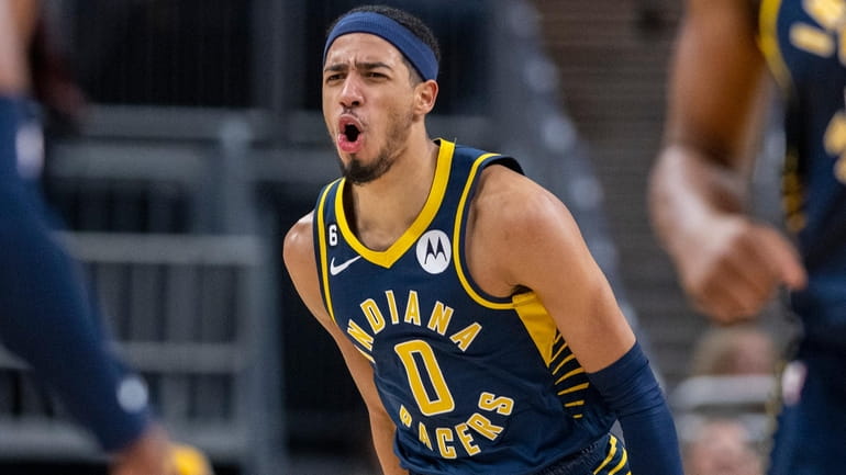 Pacers guard Tyrese Haliburton reacts after scoring during the first half...