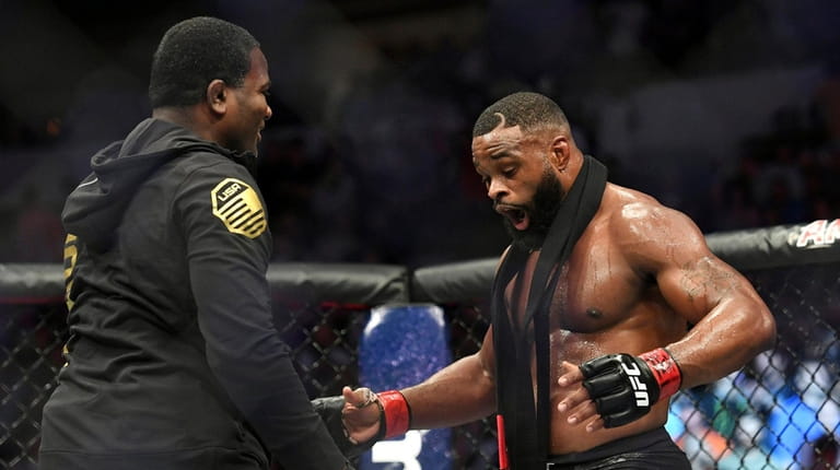 Tyron Woodley, right, reacts after defeating Darren Till by submission...