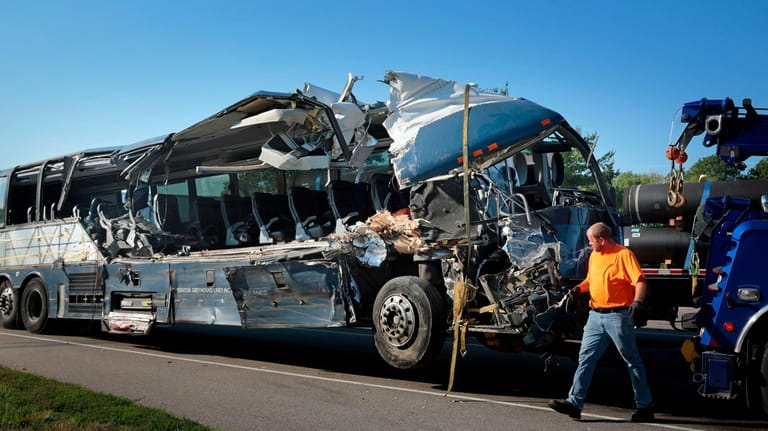 A damaged Greyhound bus is prepared for transport on Wednesday,...