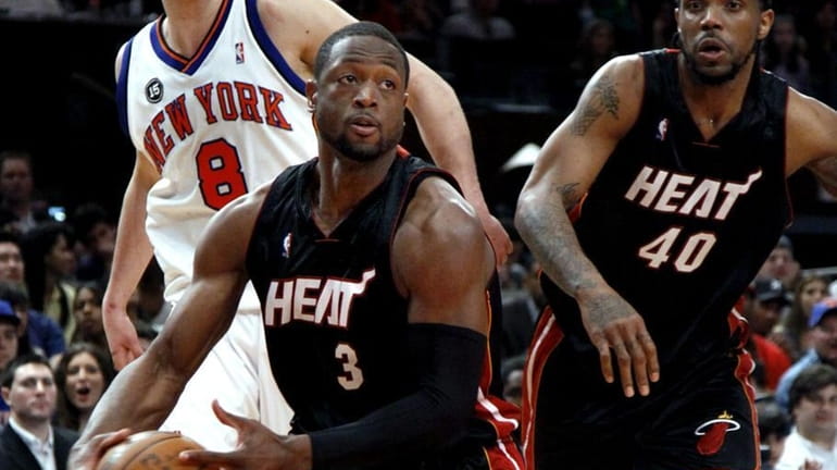 Miami Heat's Dwyane Wade drives to the basket past New...
