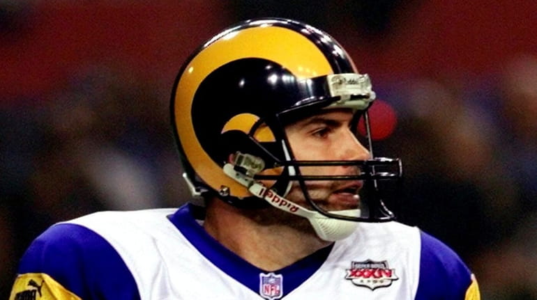 St. Louis Rams quarterback Kurt Warner scrambles out of the...