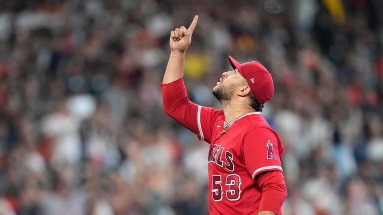 Los Angeles Angels' Carlos Estevez celebrates after a baseball game...